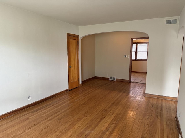 2740 N 61st St, Milwaukee, WI 53210 - empty room with arched walkways, light wood-type flooring, and baseboards