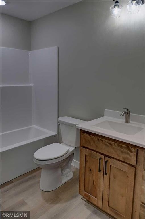 622 Pondhurst Dr, Amery, WI 54001 - bathroom with vanity, wood finished floors, and  shower combination