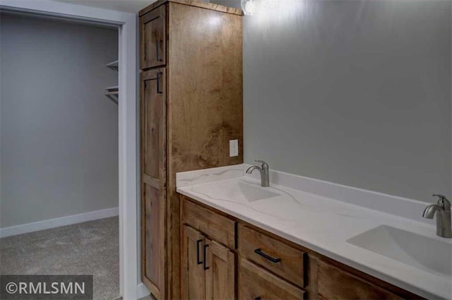 622 Pondhurst Dr, Amery, WI 54001 - bathroom featuring double vanity and baseboards