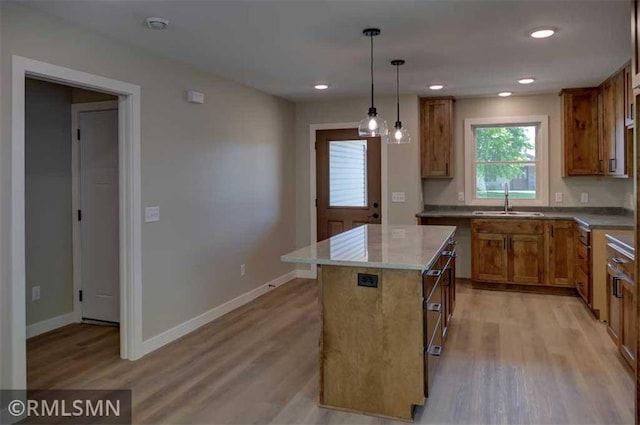 622 Pondhurst Dr, Amery, WI 54001 - kitchen featuring brown cabinetry, light wood-style floors, pendant lighting, a center island, and recessed lighting