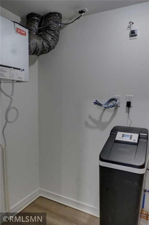 622 Pondhurst Dr, Amery, WI 54001 - laundry area featuring wood finished floors and water heater