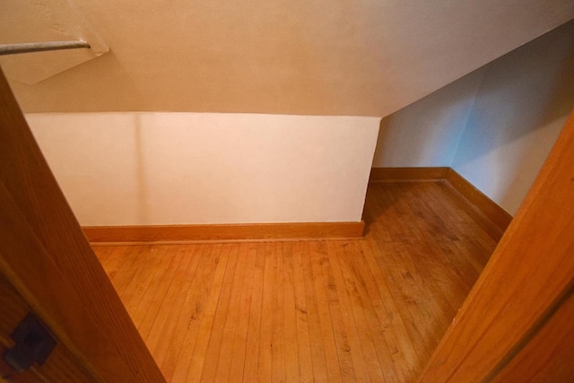 1139 W Highland St, Whitewater, WI 53190 - bonus room featuring wood-type flooring, lofted ceiling, and baseboards