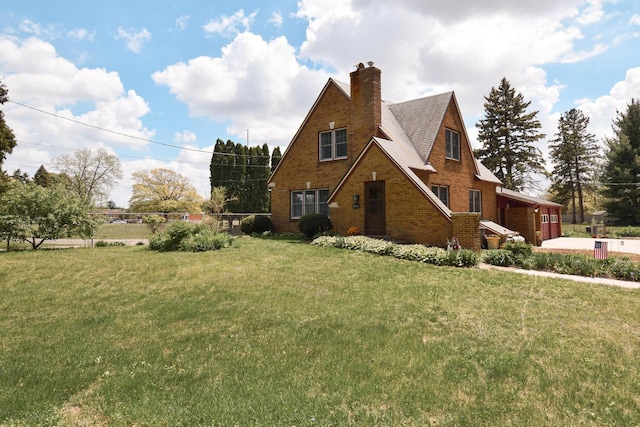 1139 W Highland St, Whitewater, WI 53190 - view of side of home with a chimney, brick siding, a garage, and driveway