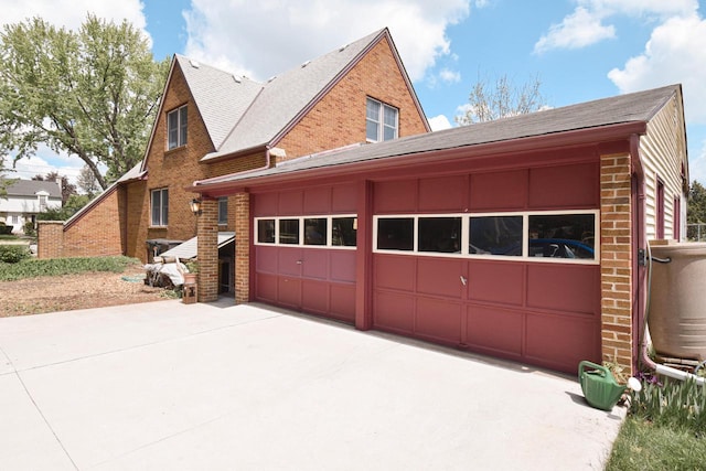 1139 W Highland St, Whitewater, WI 53190 - view of property exterior featuring brick siding, roof with shingles, and driveway