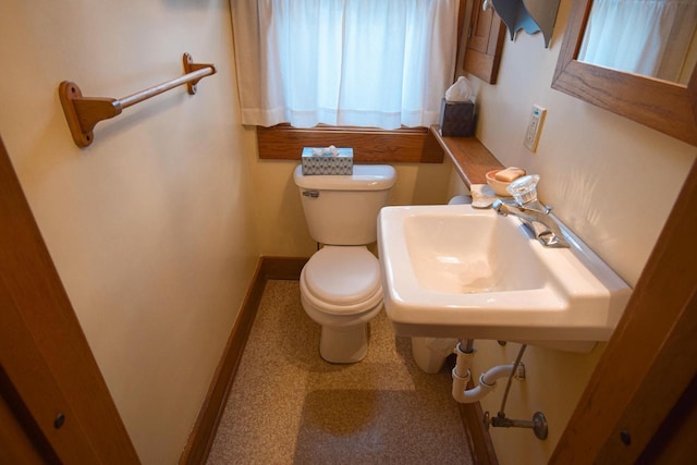1139 W Highland St, Whitewater, WI 53190 - bathroom with toilet, a sink, and baseboards