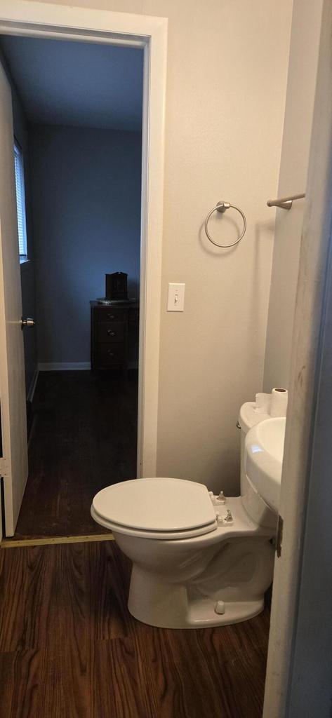 2112 Virginia St, Racine, WI 53405 - bathroom with toilet, wood finished floors, and baseboards