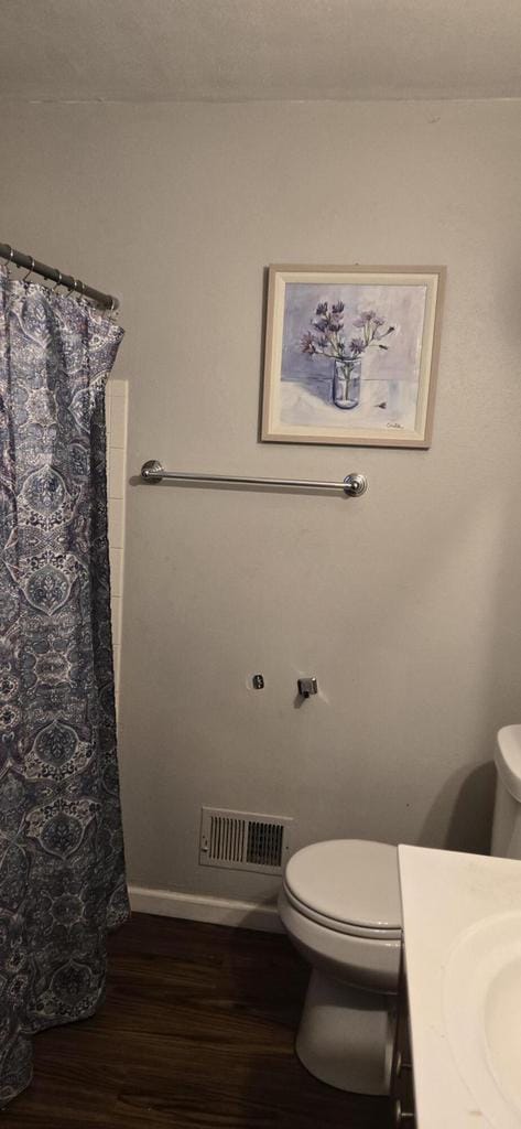 2112 Virginia St, Racine, WI 53405 - full bath featuring toilet, wood finished floors, vanity, and a shower with curtain