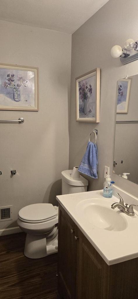 2112 Virginia St, Racine, WI 53405 - bathroom featuring vanity, toilet, and wood finished floors