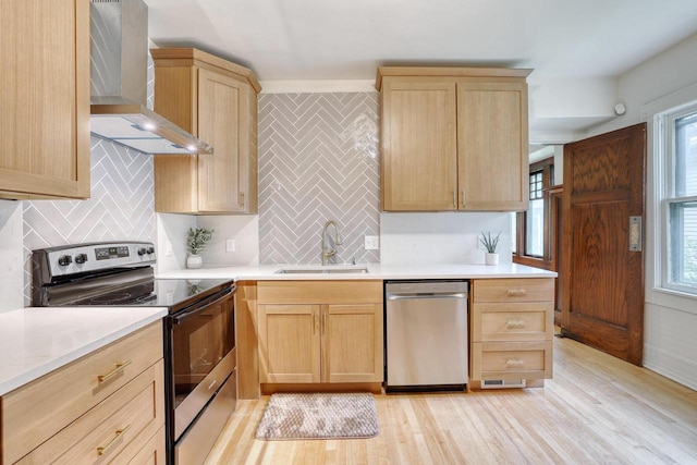 1551 N 50th St, Milwaukee, WI 53208 - kitchen with stainless steel appliances, wall chimney exhaust hood, a sink, and light brown cabinets