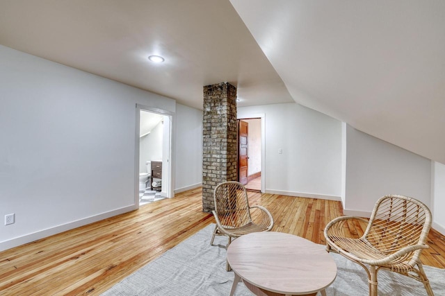 1551 N 50th St, Milwaukee, WI 53208 - sitting room featuring light wood-style flooring, lofted ceiling, baseboards, and ornate columns