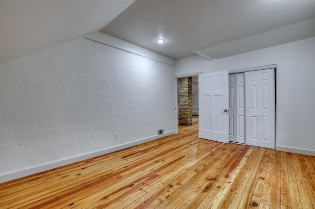 1551 N 50th St, Milwaukee, WI 53208 - unfurnished bedroom with light wood-type flooring, baseboards, a closet, and lofted ceiling
