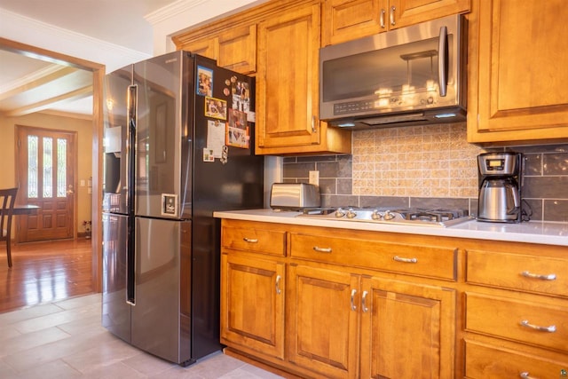23920 US Highway 2, Ashland, WI 54806 - kitchen featuring stainless steel appliances, brown cabinets, crown molding, light countertops, and backsplash