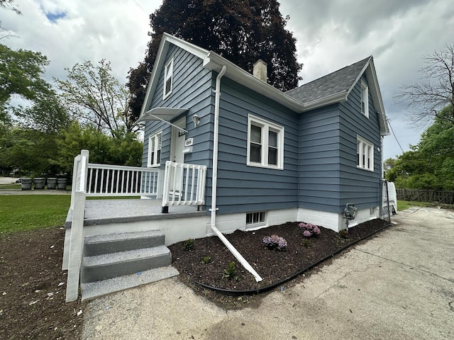 4960 N 58th St, Milwaukee, WI 53218 - view of side of home featuring a chimney and a shingled roof