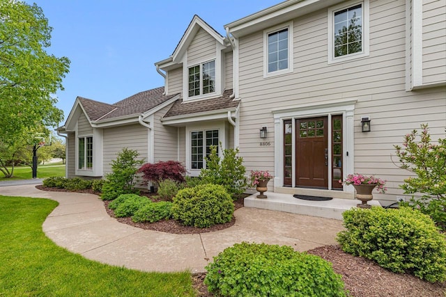 8806 W Daventry Rd, Mequon, WI 53097 - view of front of home with a shingled roof and a front lawn