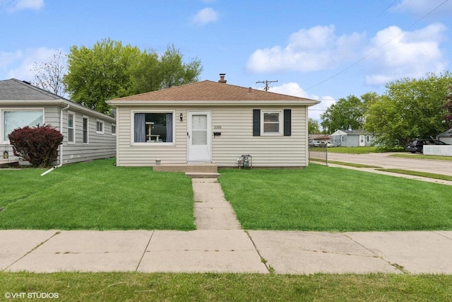 2300 W Lawn Ave, Racine, WI 53405 - view of front facade featuring a front lawn and a shingled roof