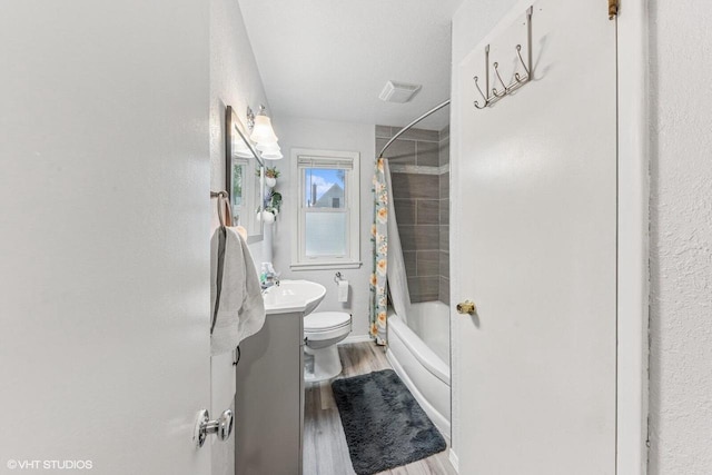 2300 W Lawn Ave, Racine, WI 53405 - full bath with toilet, wood finished floors, shower / bath combo with shower curtain, and a sink