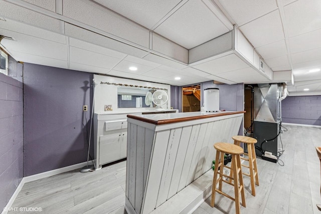 2300 W Lawn Ave, Racine, WI 53405 - kitchen with light wood-style flooring, baseboards, a drop ceiling, and heating unit