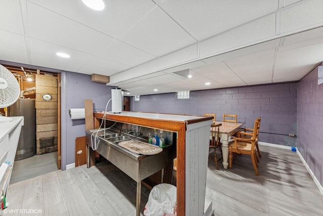 2300 W Lawn Ave, Racine, WI 53405 - indoor dry bar featuring light wood-style flooring, baseboards, and concrete block wall