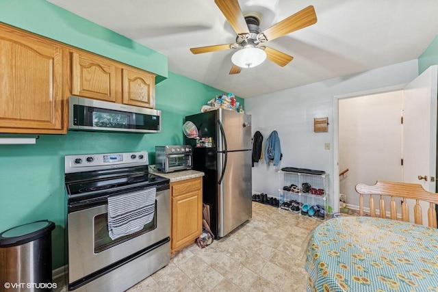 2300 W Lawn Ave, Racine, WI 53405 - kitchen with stainless steel appliances, ceiling fan, and light countertops