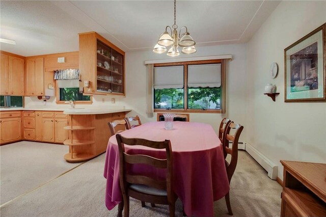 407 S Scott St, Elmwood, WI 54740 - dining area featuring light carpet, a chandelier, and a baseboard radiator