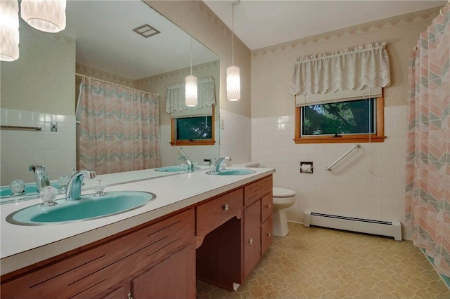 407 S Scott St, Elmwood, WI 54740 - bathroom featuring a baseboard radiator, tile walls, toilet, double vanity, and tile patterned floors
