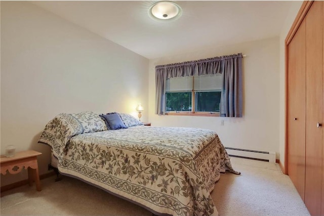 407 S Scott St, Elmwood, WI 54740 - bedroom with a baseboard radiator, light colored carpet, a closet, and baseboards