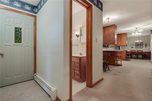 407 S Scott St, Elmwood, WI 54740 - foyer with baseboard heating, light colored carpet, and a ceiling fan