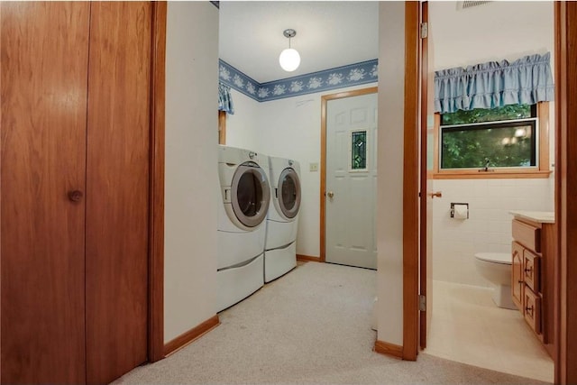 407 S Scott St, Elmwood, WI 54740 - washroom featuring washing machine and clothes dryer, light colored carpet, and baseboards