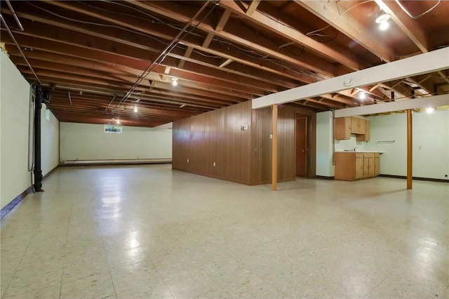 407 S Scott St, Elmwood, WI 54740 - finished below grade area with baseboards, light floors, and a baseboard radiator