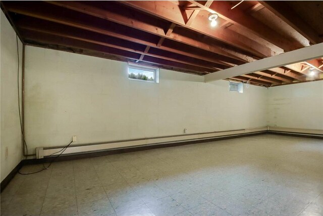 407 S Scott St, Elmwood, WI 54740 - below grade area with baseboard heating, tile patterned floors, and concrete block wall