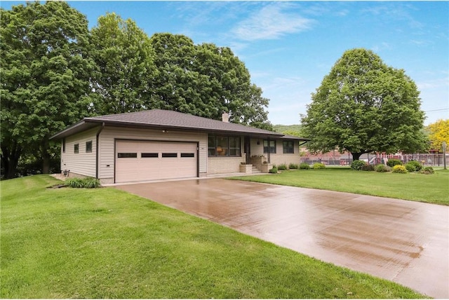 407 S Scott St, Elmwood, WI 54740 - ranch-style home with an attached garage, a front yard, concrete driveway, and a chimney