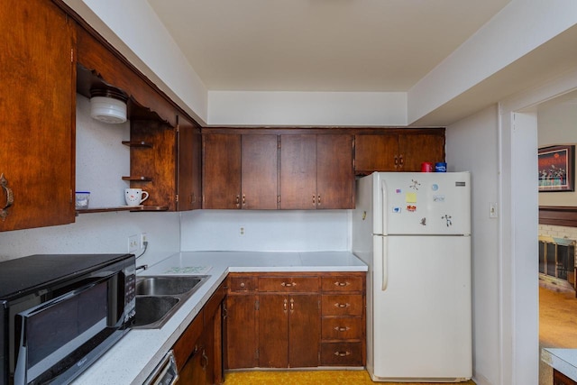7312 5th Ave, Kenosha, WI 53143 - kitchen featuring freestanding refrigerator, black microwave, a sink, and light countertops