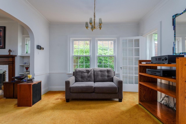 7312 5th Ave, Kenosha, WI 53143 - sitting room with light carpet, ornamental molding, a chandelier, a brick fireplace, and arched walkways