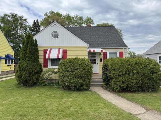 7715 18th Ave, Kenosha, WI 53143 - view of front of house featuring roof with shingles and a front yard