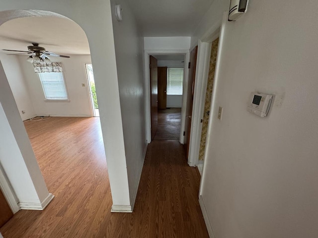 7715 18th Ave, Kenosha, WI 53143 - corridor with wood finished floors, arched walkways, and baseboards