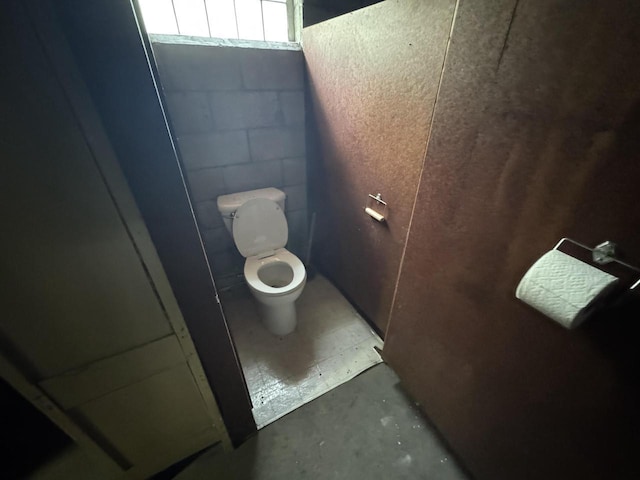 7715 18th Ave, Kenosha, WI 53143 - bathroom with toilet, unfinished concrete flooring, and concrete block wall