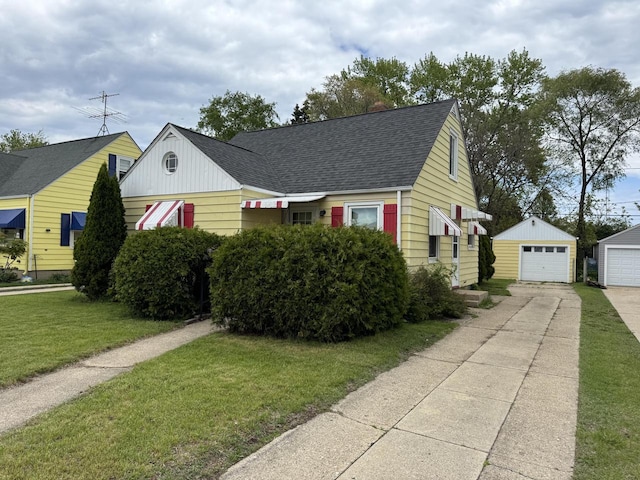 7715 18th Ave, Kenosha, WI 53143 - view of front of home featuring an outdoor structure, driveway, a shingled roof, a front lawn, and a detached garage