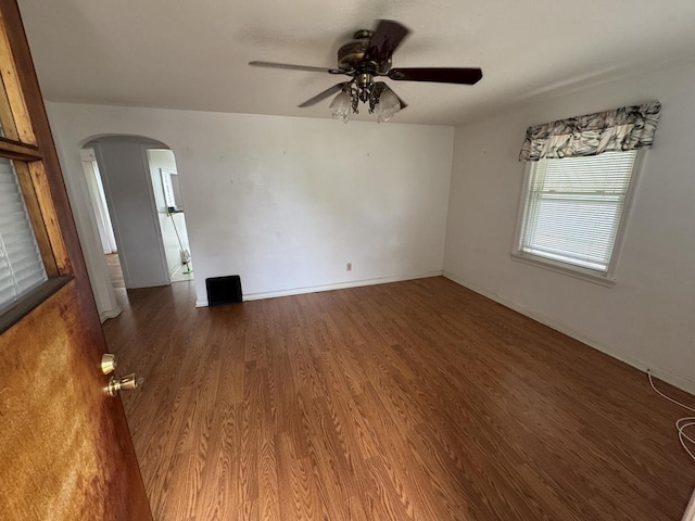 7715 18th Ave, Kenosha, WI 53143 - spare room with arched walkways, ceiling fan, wood finished floors, and baseboards