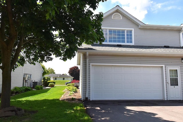 10320 W Whitnall Edge Cir Unit A, Franklin, WI 53132 - garage featuring central AC unit and driveway