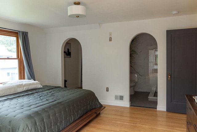 2707 Mason St, Madison, WI 53705 - bedroom with arched walkways and light wood-type flooring
