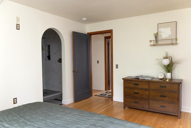 2707 Mason St, Madison, WI 53705 - bedroom with arched walkways and light wood-style floors