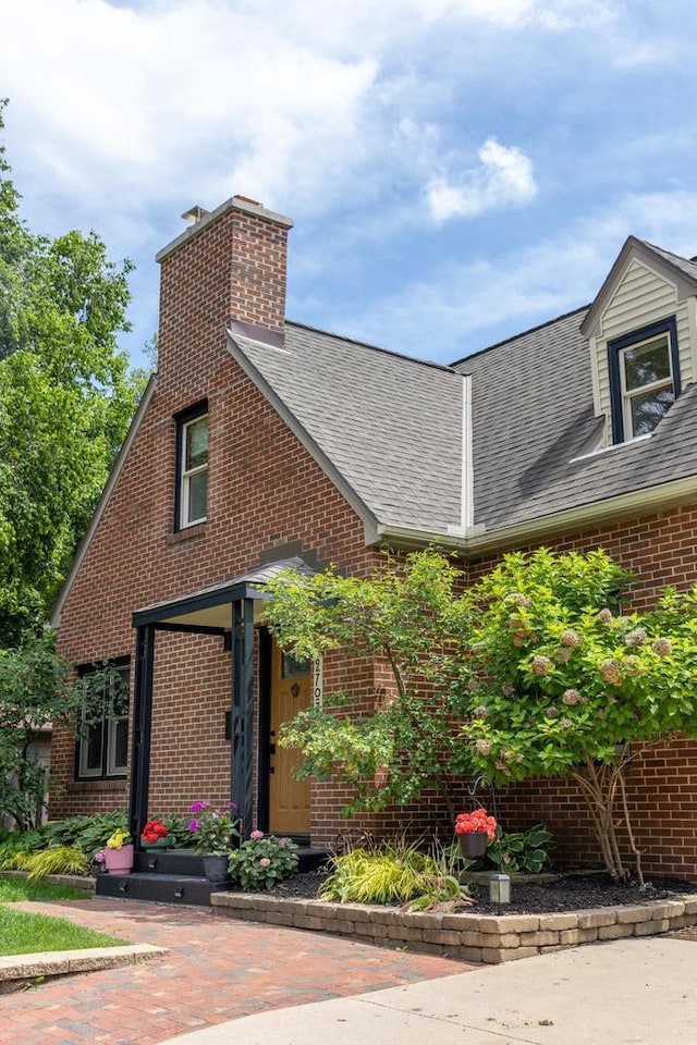 2707 Mason St, Madison, WI 53705 - view of property exterior with a chimney, brick siding, and a shingled roof