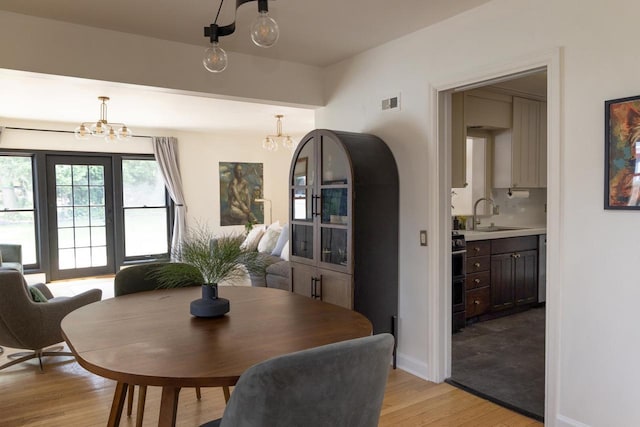 2707 Mason St, Madison, WI 53705 - dining space with a chandelier and light wood-type flooring
