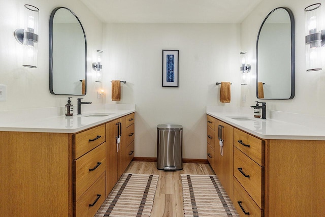 6633 W Beacon Hill Pl, Franklin, WI 53132 - full bathroom featuring wood finished floors, two vanities, and baseboards