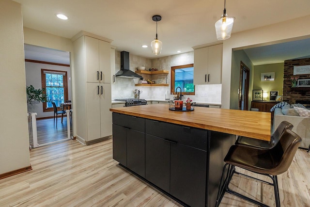 6633 W Beacon Hill Pl, Franklin, WI 53132 - kitchen with wall chimney range hood, butcher block counters, backsplash, hanging light fixtures, and white cabinets