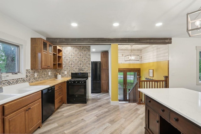 N62W23527 Sliver Spring Dr, Sussex, WI 53089 - kitchen featuring black appliances, decorative backsplash, open shelves, beamed ceiling, and light wood-type flooring