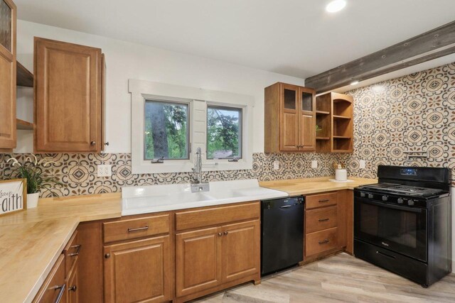 N62W23527 Sliver Spring Dr, Sussex, WI 53089 - kitchen featuring black appliances, open shelves, brown cabinetry, backsplash, and light countertops