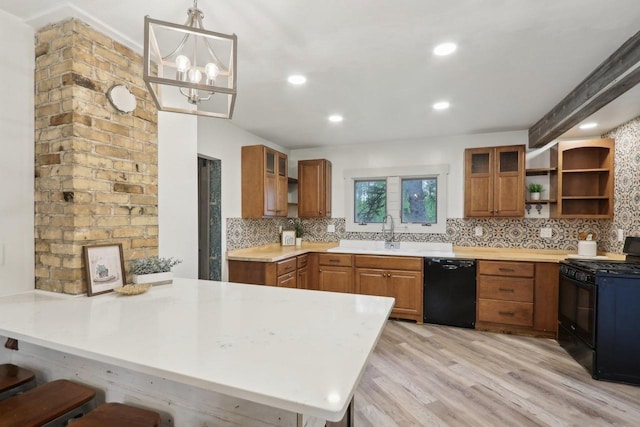 N62W23527 Sliver Spring Dr, Sussex, WI 53089 - kitchen with black appliances, open shelves, a peninsula, a breakfast bar, and tasteful backsplash