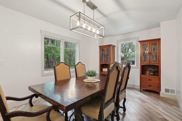 N62W23527 Sliver Spring Dr, Sussex, WI 53089 - dining room with light wood-style flooring, a chandelier, and baseboards