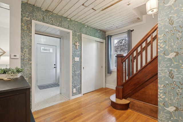 N62W23527 Sliver Spring Dr, Sussex, WI 53089 - entrance foyer with wallpapered walls, wood finished floors, stairs, baseboards, and wooden ceiling